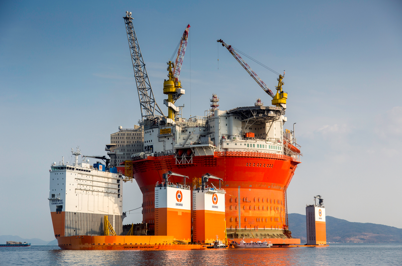Illustration for article titled Here's The Largest Oil Rig Ever On Top Of The Largest Transport Ship